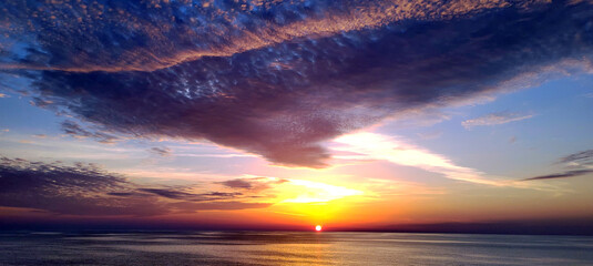 Evening beautiful dramatic sunset over sea.