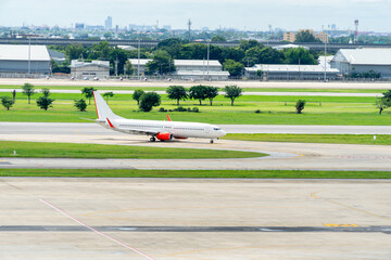 Passanger plane lands. Airplane on the platform of Airport. Runway.