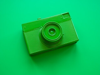 Top view of green film camera. Minimal trendy style.