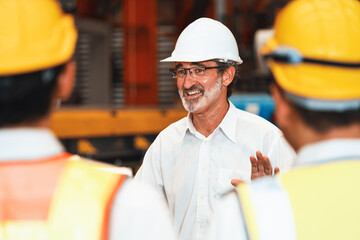 Collective factory worker and engineer gather for meeting with factory executive or manager, discussing plan and industry training program on-site work heavy industrial steel workshop. Exemplifying