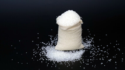 Heap of refined White Sand Sugar in burlap sack bag