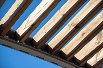 wooden roof of the gazebo overlooking the sky