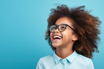 Fototapeta premium Happy School pupil, African-American girl in glasses on isolated on studio background with copy space, back to school