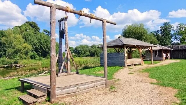 Footage of the wooden scaffold with guillotine at historical museum. Outdoors