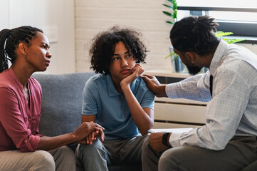 African American woman with teen son have a meeting with a psychologist. A psychotherapist session...