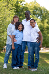 Fototapeta premium Interracial family in the park together looking happy