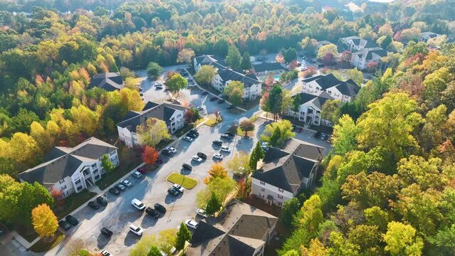 View from above of apartment residential condos between yellow fall trees in suburban area in South Carolina. American homes as example of real estate development in US suburbs
