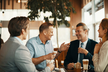 Group of business coworkers or colleagues having a business meeting in a cafe