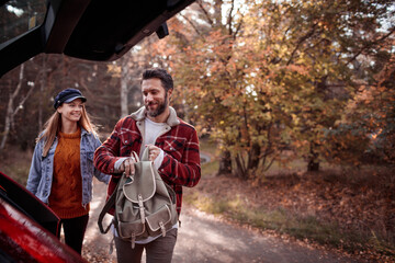 Young happy caucasian couple hiking on a park trail