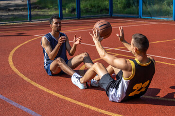 Two man friends athlete having workout together on outdoors court.