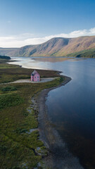 Abandoned Pink house lying by Loch Glass. True scottish landscape with heath and midges. 