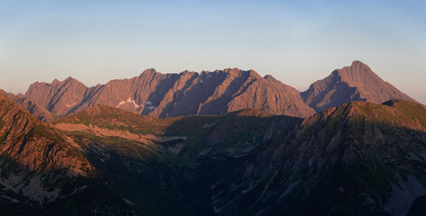 Sunset in High Tatras from Poland side. Amaizing scenery from top of the mountains. You can see Poland and Slovakia countryside meet a chamonix and enjoy hike. Iconic peak is Wielki Giewont. - obrazy, fototapety, plakaty