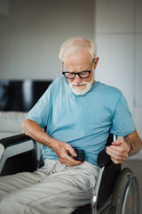 Senior man checking his blood sugar level on an insulin pump.