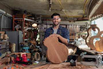 Portrait of guitar luthier small business owner in workroom - obrazy, fototapety, plakaty