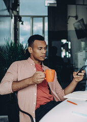 skilled programmer reading financial news on content website on cellular
