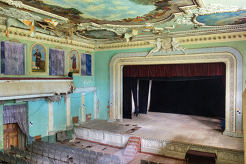 Abandoned and ruined theater stage with paintings