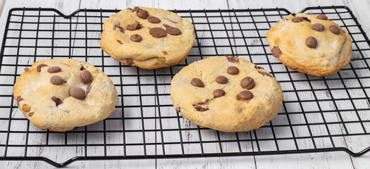 Chocolate chip cookies on metal grid over marble table