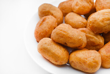 Sausages in dough on a white plate. Delicious meat appetizer in batter.
