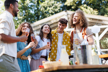 Friends and family talking and having fun at a summer grill garden party.