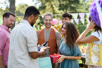 Beautiful birthday girl receiving gifts from friends and family.