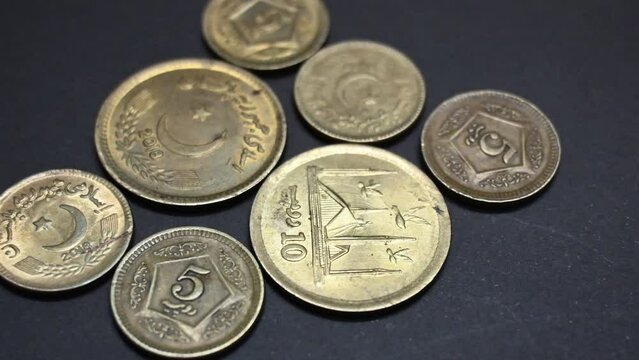Pakistani coin of rupees 10 with rupees 5 closeup, Pakistani currency isolated on black background