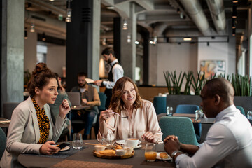 Diverse group of business people having meeting in the hotel cafe or bar
