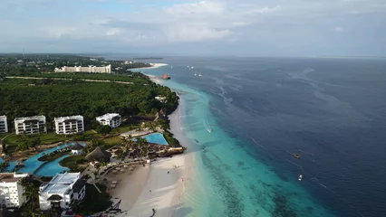 Crédence en verre imprimé Plage de Nungwi, Tanzanie Aerial view of Indian ocean and sandy beach with many luxurious resorts on the coast of the Indian ocean. Nungwi beach, Zanzibar, Africa