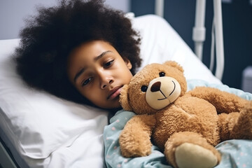 Sad African American girl patient lying on bed with teddy - obrazy, fototapety, plakaty