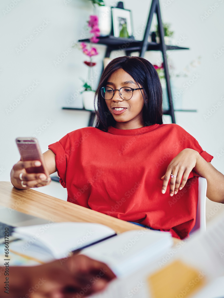 Poster cropped image of woman student read message on smartphone working at desktop with netbook