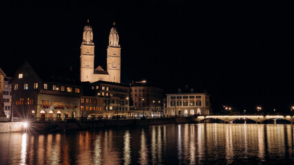 Zurich, The church Grossmunster. Zurich. Switzerland. Image of Zurich cityscape at night, evening...