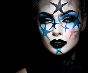Fashion editorial Concept. Closeup portrait pretty woman with chiseled features, colourful iridescent stars metallic Glitter stmakeup. illuminated dynamic composition dramatic lighting. copy space