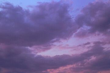 Naklejka na ściany i meble Dark sky with blue clouds at sunset. Evening sky background, dramatic sky landscape