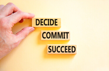 Decide commit succeed symbol. Concept word Decide Commit Succeed on beautiful wooden block. Businessman hand. Beautiful white table background. Business decide commit succeed concept. Copy space.