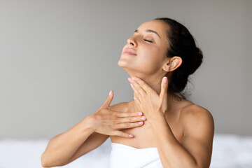 Young Lady Caring For Neck Skin Making Massage, Gray Background