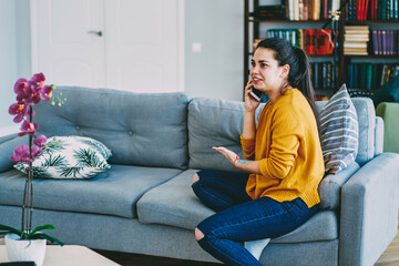  hipster girl making booking calling to service operator from home interior