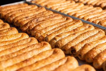 Balkans pastry borek on display in a bakery , Turkish Tepsi Boregi, Round Borek, Tray pastry
