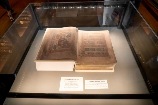 Dublin, Ireland: Book of Kells replica on display in the Long Room Library at Trinity College. Illuminated manuscript Gospel book in Latin. Book of Columba is an Irish treasure.