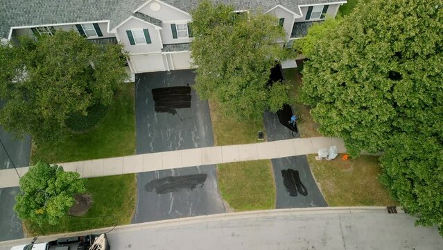 Aerial wide view of Driveway sealcoating pavement, Near private houses in the suburbs