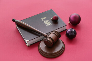 Judge's gavel with law book and Christmas balls on red background