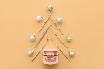 Christmas tree made of dental tools and balls on beige background