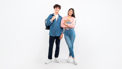 Cheerful Young Students Duo Standing With Backpacks Over White Background