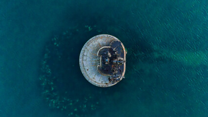 Captivating top-down view of a sea fort amid azure waters, revealing submerged rocks below