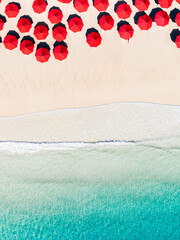 Aerial view of a beach with red umbrellas