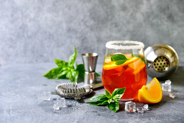 Orange cocktail with basil. - obrazy, fototapety, plakaty