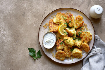Fried cauliflower with greek sauce. Top view with copy space.