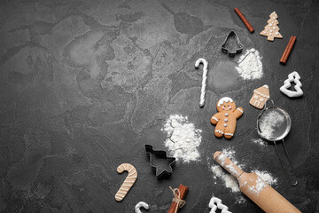 Composition with Christmas cookies, decorations and kitchen utensils on dark background