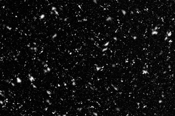 Falling down snowflakes over black background. Heavy snow overlay texture for design.