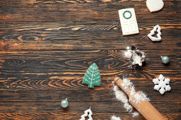 Composition with tasty Christmas cookies, decorations and kitchen utensils on wooden background