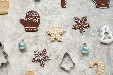 Composition with tasty Christmas cookies, decorations and cutters on grunge background