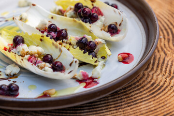 Belgium endive boats with huckleberries, nuts and cheese